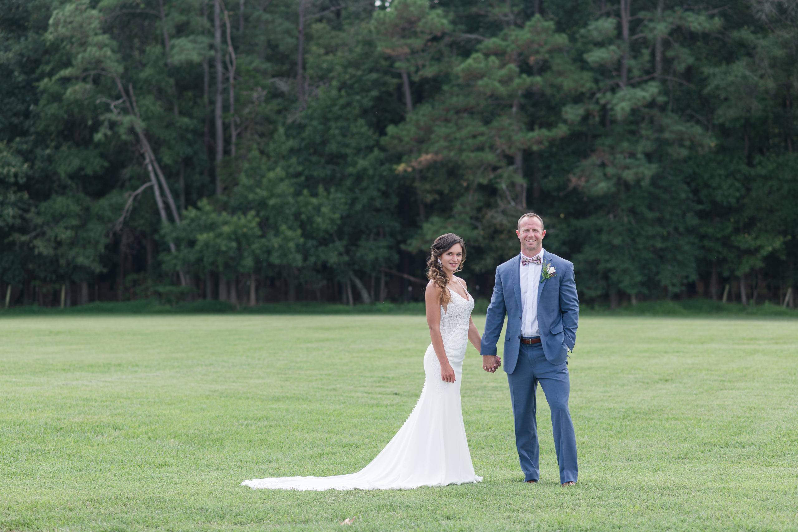 Bride and groom in open field on their wedding day at Oakdale Virginia