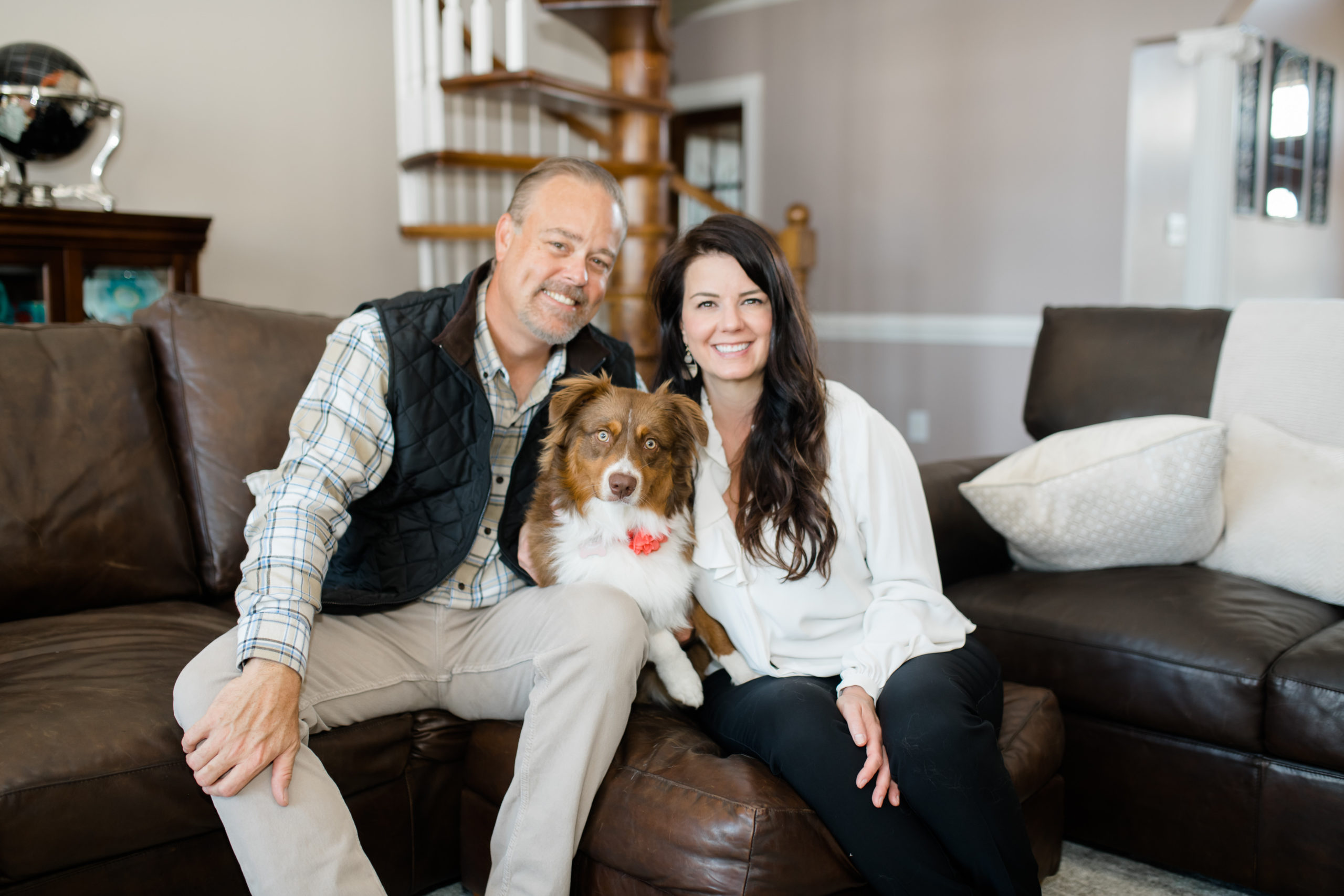 Couples in home portrait with their dog