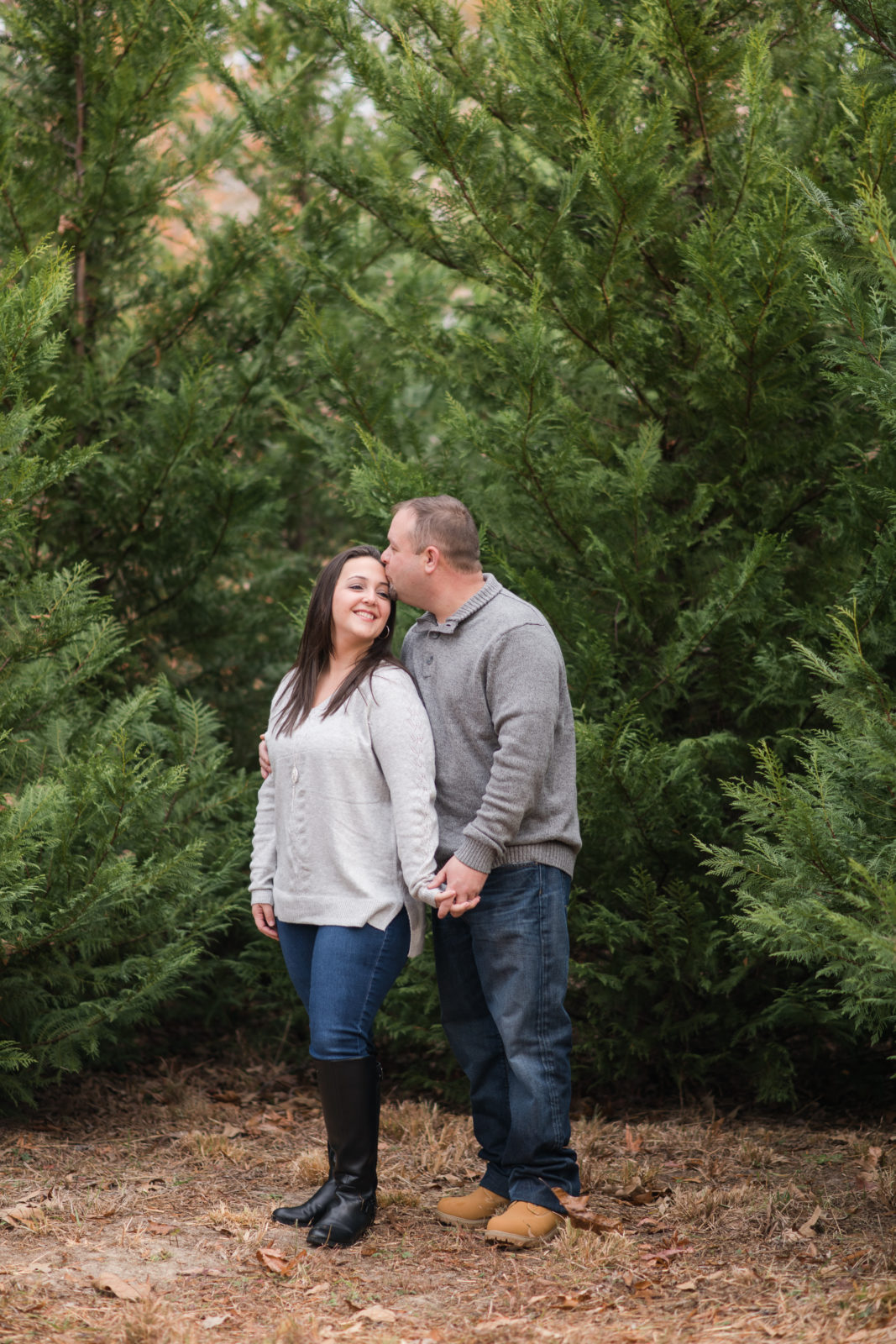 Husband in wife in christmas trees
