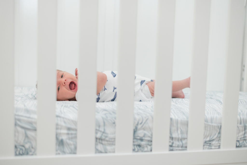 Lifestyle newborn photo in crib