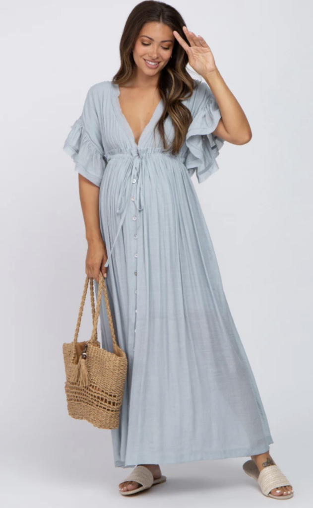 Light blue deep V-neck maxi dress with front buttons and short flowy sleeves, paired with a woven tote – perfect for a relaxed golden hour shoot.