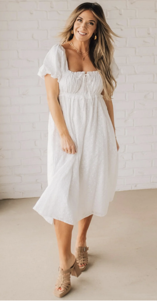 Classic white midi dress with subtle texture, puff sleeves, and a sweetheart neckline – an effortless pick for maternity or motherhood portraits.