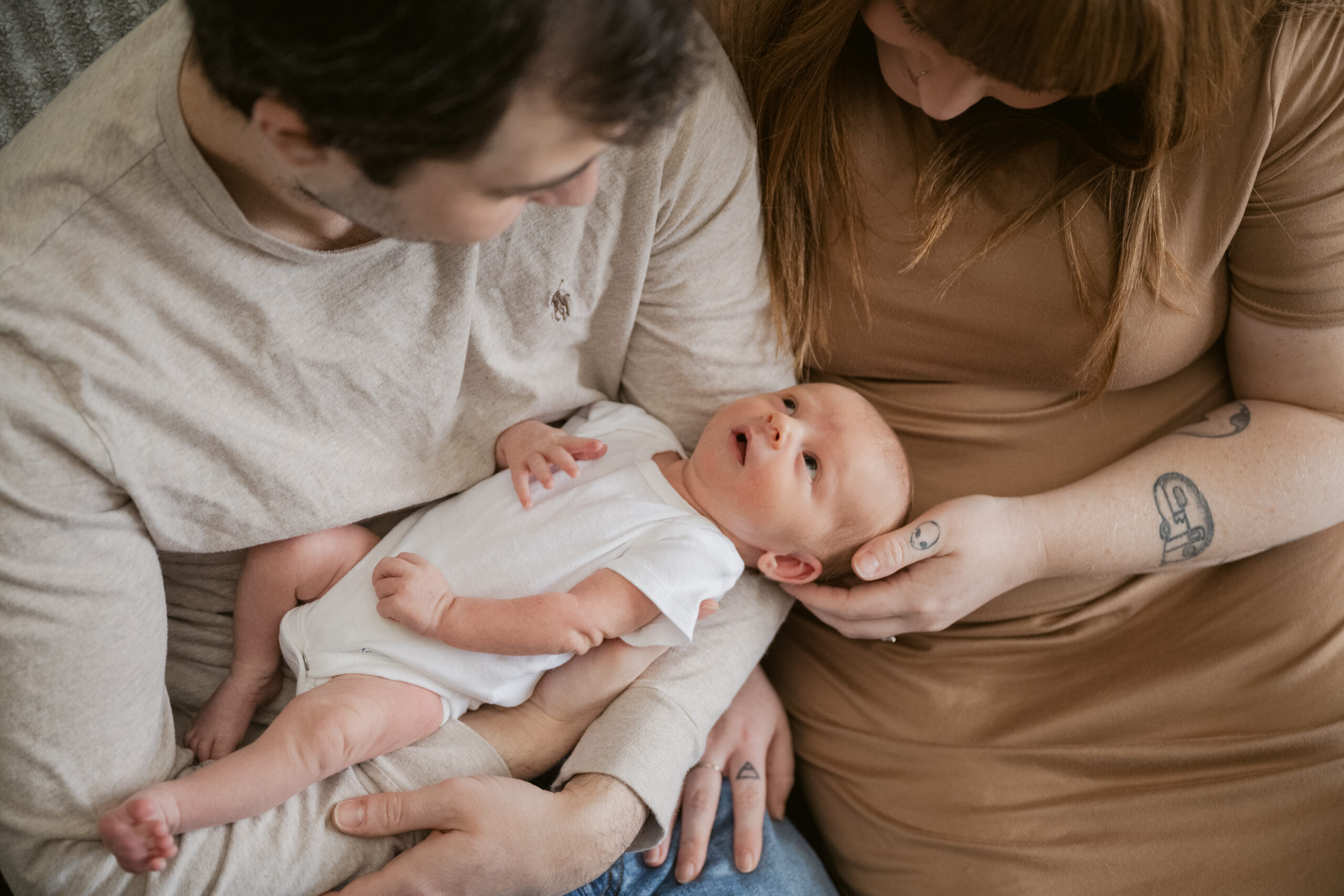 Close-up of a newborn in a soft, neutral outfit during an at-home photo session in Mechanicsville.