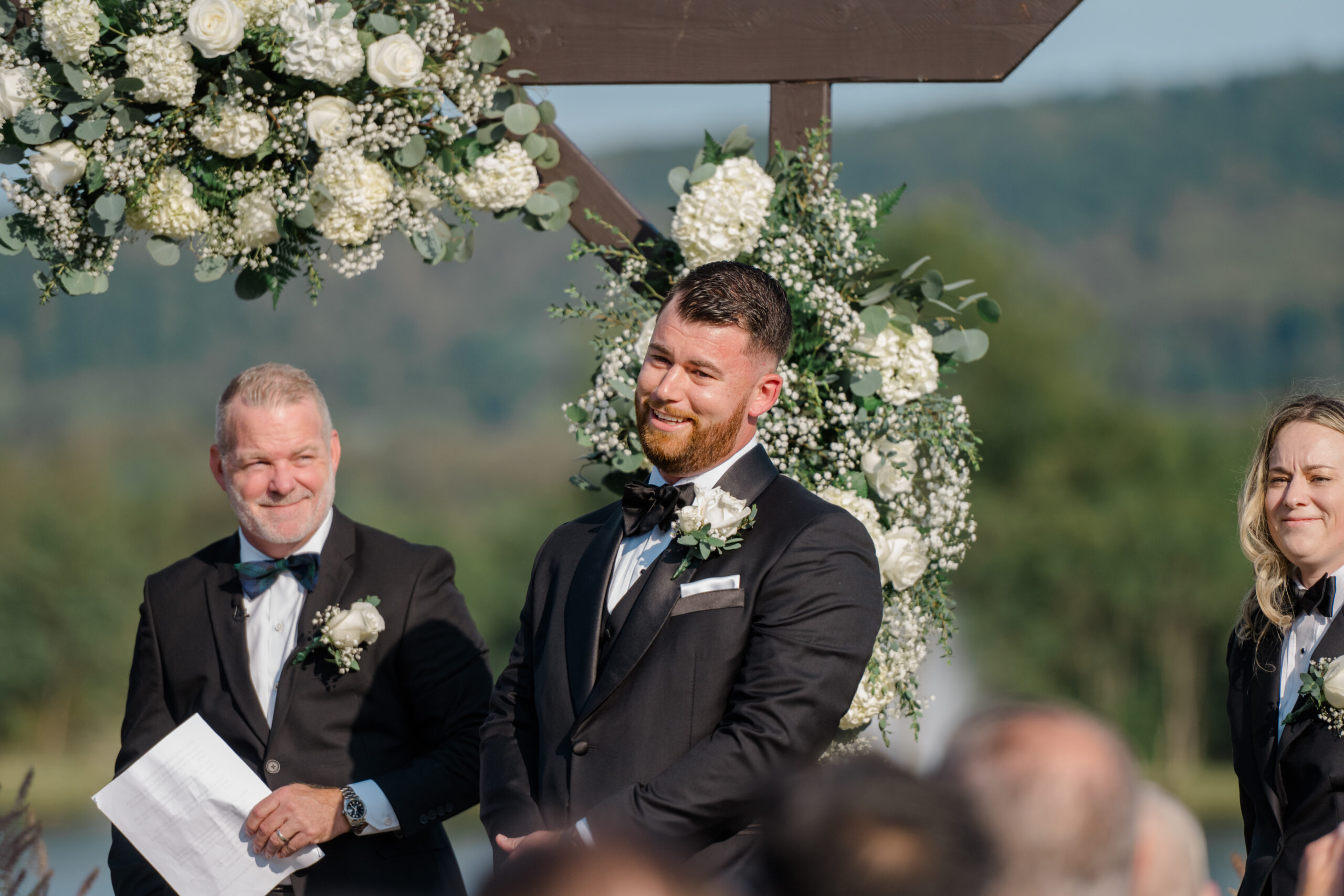 Groom smiling emotionally during the outdoor wedding ceremony with mountain views at Gordon Springs